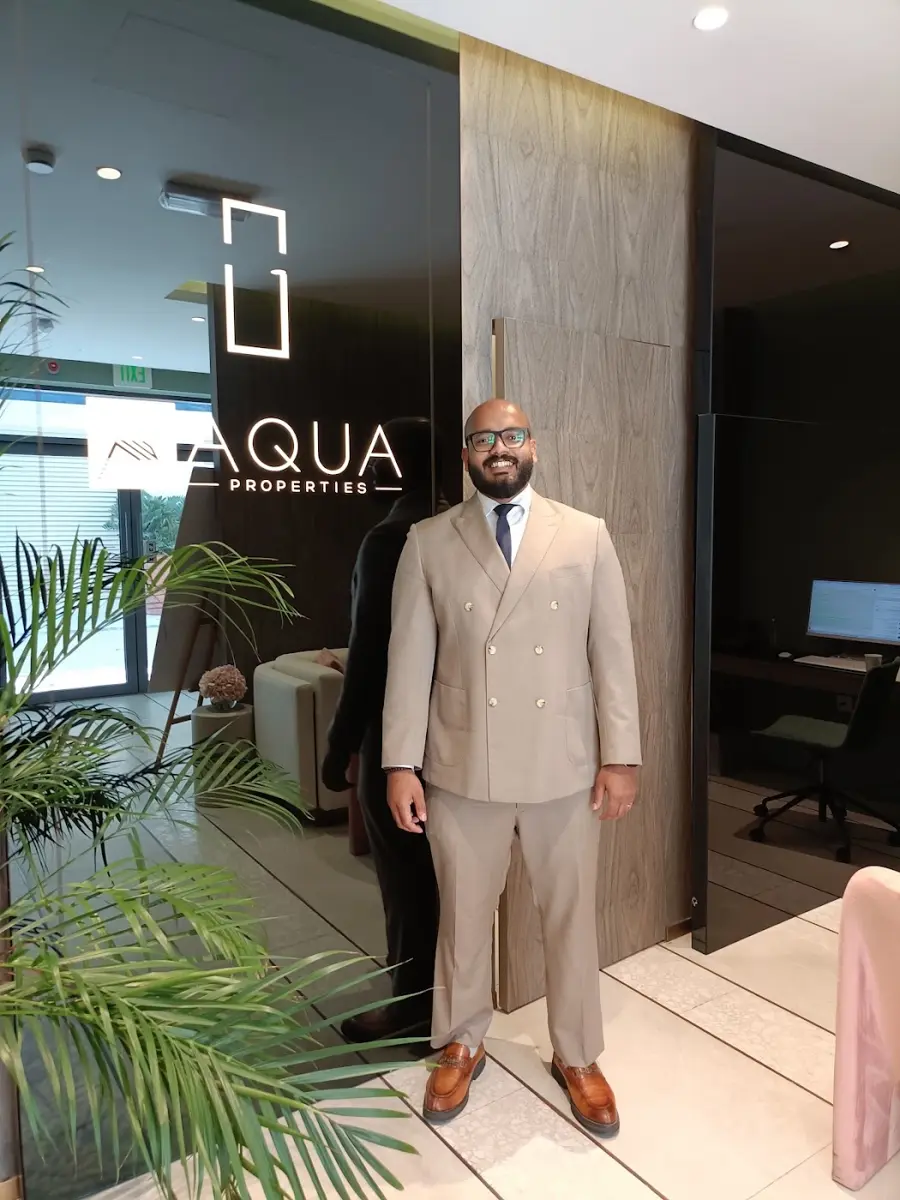 The AQUA Properties logo wall inside the office